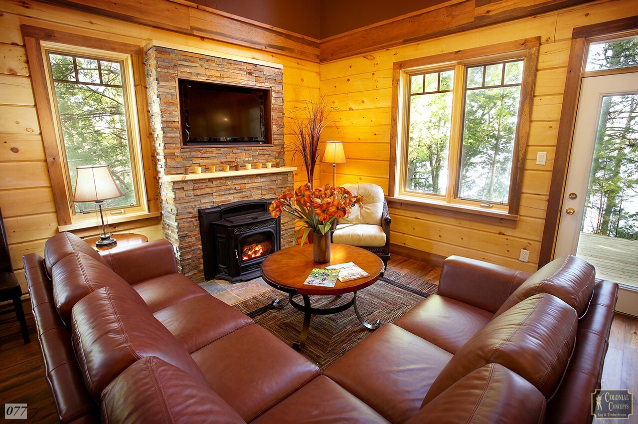 log home with stone fireplace and leather couches near ottawa ontario